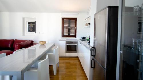 a kitchen with a counter top and a refrigerator at Vila Visnjic in Grebaštica