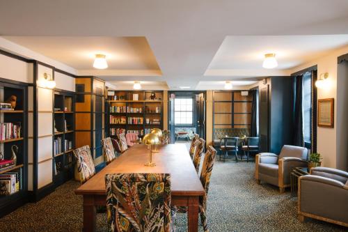 a library with a long wooden table and chairs at Hotel Clermont Atlanta, by Oliver in Atlanta