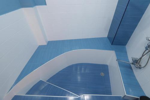 a blue tile floor in a bathroom with a shower at Garnim guest house in Yerevan