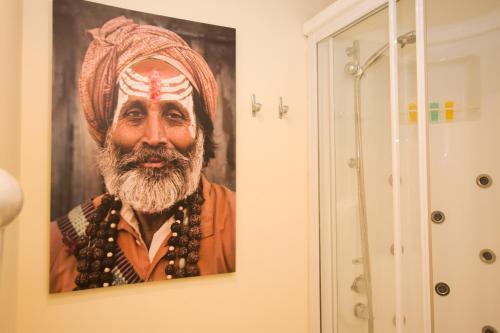 a painting of a man hanging on a wall at Residencial Terra de Mar Calpe, Grupo Terra de Mar, alojamientos con encanto in Calpe