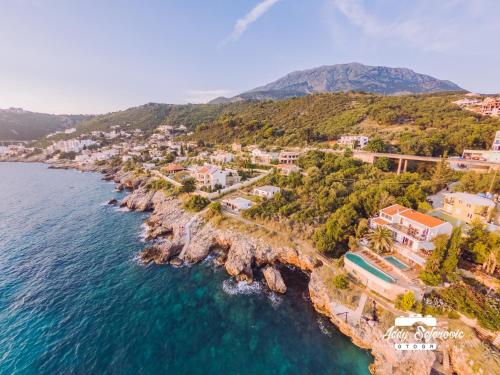 an aerial view of a village on a rocky coast at Resort Stikovic in Dobra Voda