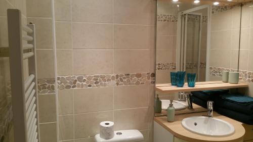 a bathroom with a sink and a toilet and a mirror at Le Studio 54 in Honfleur