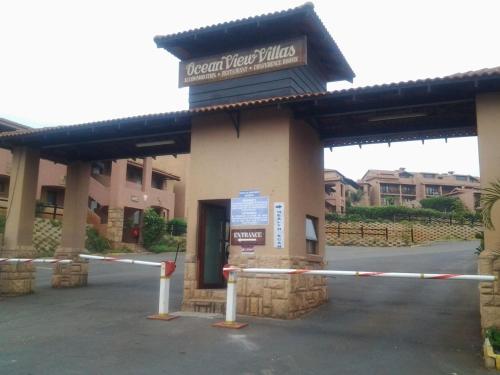 a building with a sign that reads covenant view hotel at Ocean View Villas Unit G07 in Port Edward