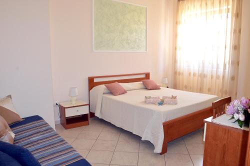 a bedroom with a large bed and a window at Le Grotte in Castro di Lecce