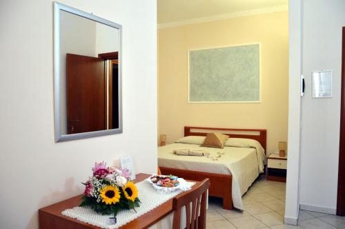 a hotel room with a bed and a mirror at Le Grotte in Castro di Lecce