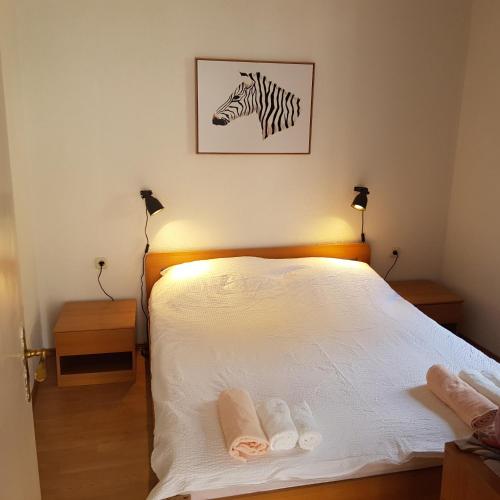 a bedroom with a bed with a zebra picture on the wall at Holiday home Marija in Karlobag