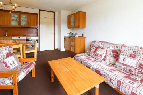 a living room with a couch and a table at Spacious Family Apartment, Immeuble Gemeaux in Flaine