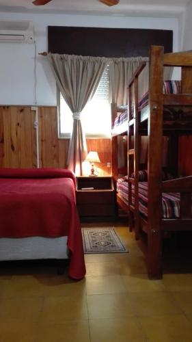 a bedroom with two bunk beds and a window at Hotel Residencial Casal in La Paz