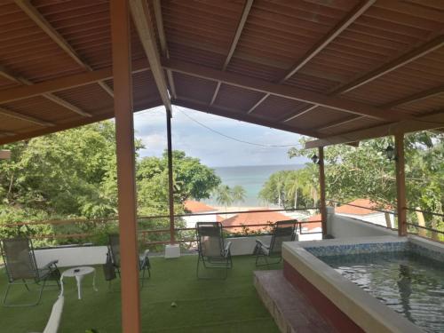 a patio with a pool and a table and chairs at Hotel Gerald in Contadora