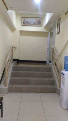 an empty hallway with stairs in a building at Meaco Royal Hotel - Plaridel in Plaridel