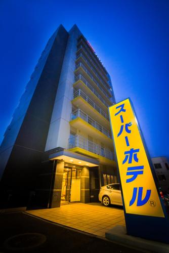 a building with a sign in front of it at Super Hotel Hachinohe Tennen Onsen in Hachinohe