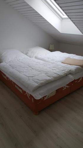 a large bed in a room with a ceiling at Mecklenburger Straße 3 in Moltow
