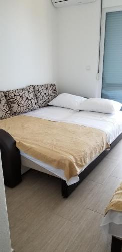 a bedroom with a large bed with a blanket on it at Apartment Vila Mirela in Krimovice