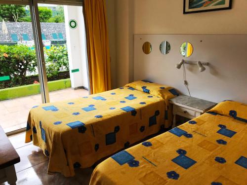 Katil atau katil-katil dalam bilik di Apartamentos Los Aguacates