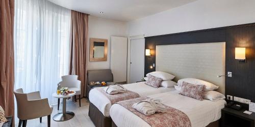 Ένα ή περισσότερα κρεβάτια σε δωμάτιο στο Best Western Plus Hotel Carlton Annecy