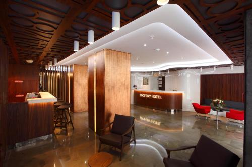 a lobby with chairs and a bar in a building at Victory Hotel & Spa Istanbul in Istanbul