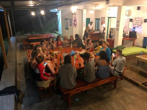 a group of people sitting at tables in a restaurant at Ella Escapade Hostel in Ella