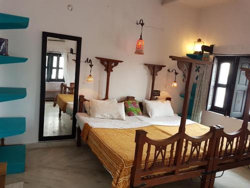 a bedroom with two beds and a large mirror at Inn Seventh Heaven in Pushkar