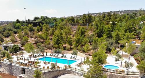 an aerial view of a resort with two pools at Mountain Breeze Lodge & Resort in Al Salt