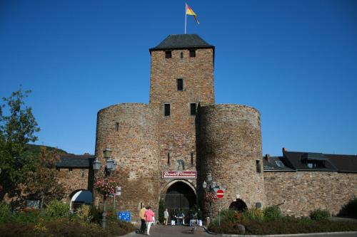 a large brick tower with a flag on top of it at Hotel Ännchen in Bad Neuenahr-Ahrweiler