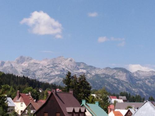 a town with mountains in the background with houses at Apartments Durmitor in Žabljak