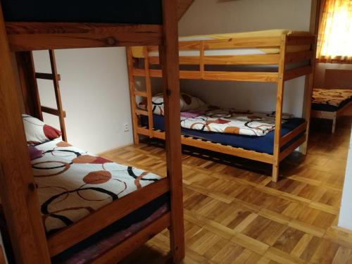 two bunk beds in a room with wooden floors at Ing. Martin Čech Kielar in Hlohovec