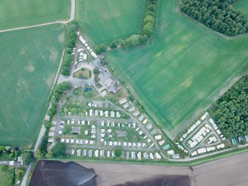 an aerial view of a building in a field at Drumshademuir Caravan & Camping Park in Glamis