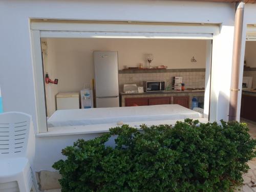 a view of a kitchen with a large open window at Triscina 83 in Triscina