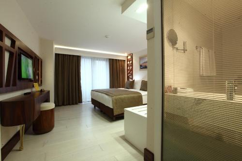 a hotel room with a bed and a bathroom at Victory Hotel & Spa Istanbul in Istanbul