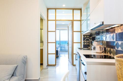 a kitchen with a view of the ocean at Meltemi Coast Suites in Rethymno Town