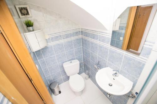 a bathroom with a toilet and a sink at The Maze Apartment in Ljubljana
