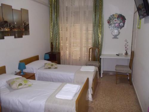 a bedroom with two beds and a window at Victoria in Catania