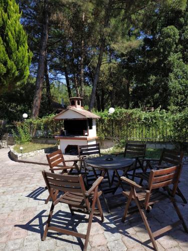 a patio with a table and chairs and a grill at BLEU- VERT in Prinos