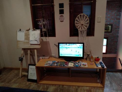 a desk with a computer monitor on top of it at Casa 24 Puerto Iguazu in Puerto Iguazú