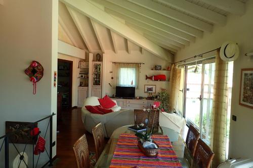 a living room with a couch and a table at B&B Dolce vista al lago Lugano in Porto Ceresio