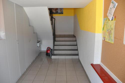 a hallway with a stairwell with a stair case at Budziar - kwatery nad morzem in Darłowo