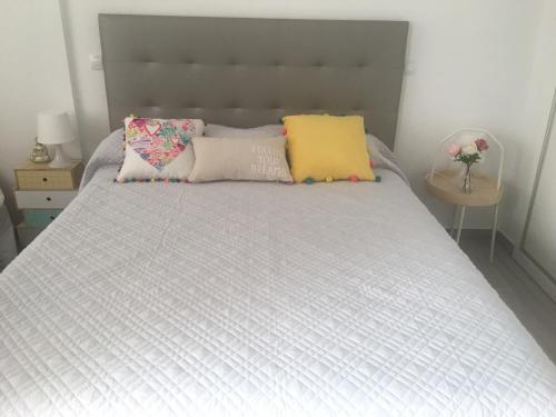 a bed with two pillows on top of it at Sunny Apartment Puerto Rico in Puerto Rico de Gran Canaria