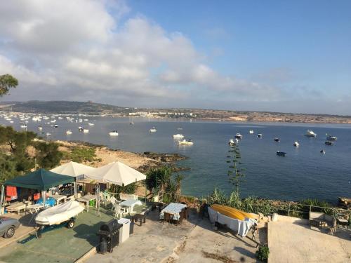 a view of a harbor with boats in the water at Mellieha in Għajn Żejtuna