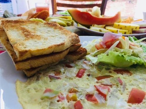 a plate of food with toast and a salad at Victory Villa Sigiriya in Sigiriya