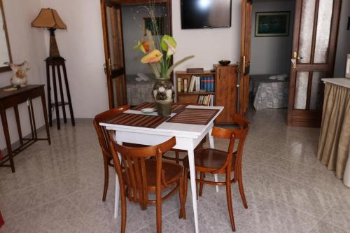 a dining room with a white table and chairs at Casa Antica in Fasano
