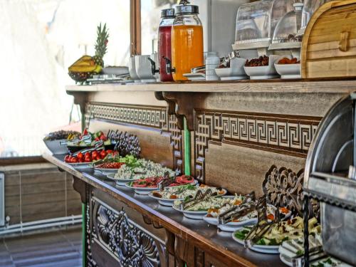 a buffet line with plates of food on display at Milat Cave Hotel in Goreme