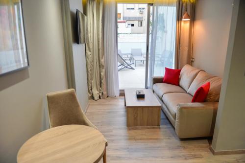 a living room with a couch and a table at Le 22 Appart'Hotel in Casablanca