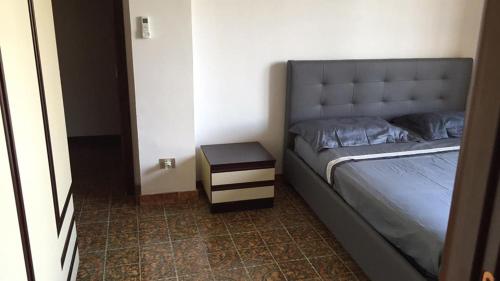 a bedroom with a bed and a night stand at Villa DonnAnna in Cariati