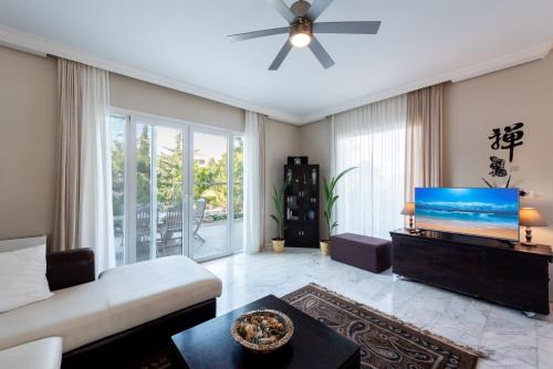 a living room with a couch and a flat screen tv at Nicole's garden villa in Kallithea Rhodes