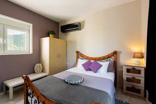 a bedroom with a bed and a window at Nicole's garden villa in Kallithea Rhodes
