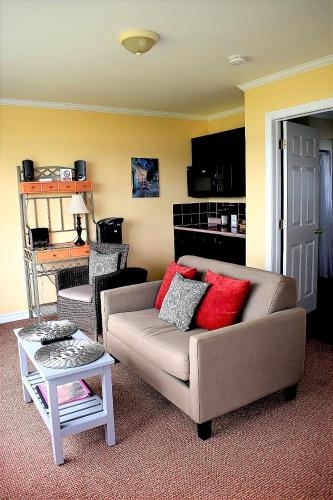 a living room with a couch and a table at Seascape Coastal Retreat - 2 ADULTS ONLY - HOT TUB AND WITHOUT HOT TUB OCEANFRONT PROPERTY in Ingonish