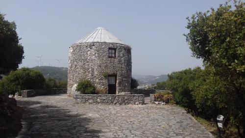 a small stone building with a roof on a stone road at Cabeço dos Três Moinhos in Rio Maior
