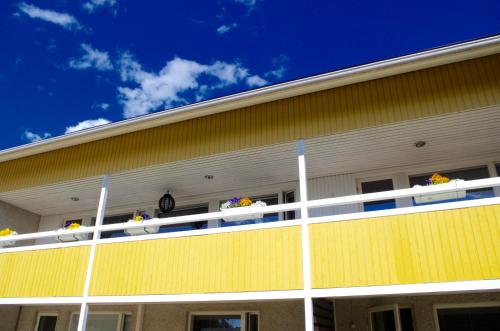 a yellow building with flowers on the balcony at GuestHouse Arctic Heart in Rovaniemi