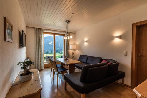 a living room with a couch and a table at Haus Sonnblick in Abtenau