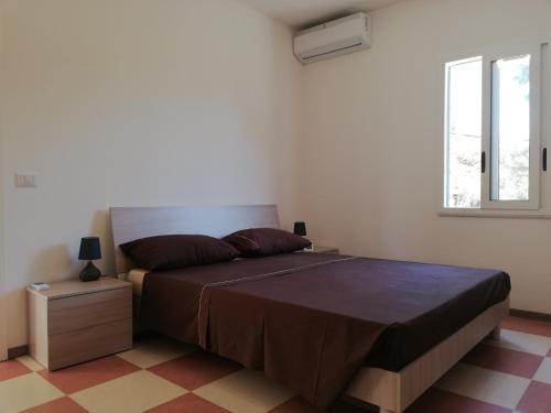 a bedroom with a large bed and a window at New Rooms on The Beach in Pozzallo